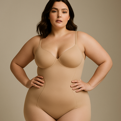 Ultra-professional studio photo of a confident plus-size woman with fair skin wearing a high-quality beige body shaper with thin straps. The shapewear fits her perfectly, enhancing her natural curves and creating a very flattering silhouette. She looks confident, beautiful, and empowered. The background is plain and softly lit, resembling a luxury fashion campaign for premium shapewear brands like Skims or Leonisa. Studio lighting, editorial aesthetic, clean and high-end look.